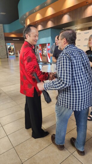 Dr. Wang greeting attendees at his movie premiere