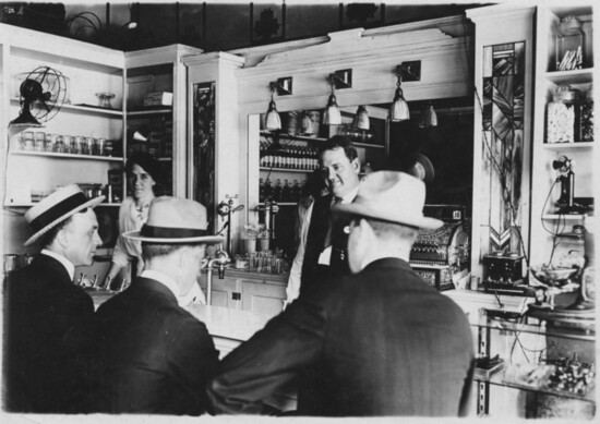 Employees and customers at Meta Burrows Pharmacy and soda fountain, 1940’s (1996.11.107)