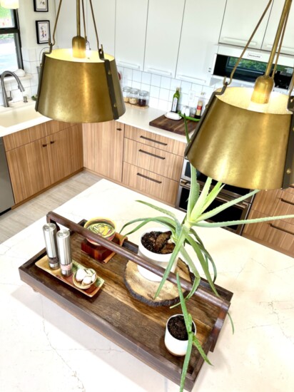 Warmer tones and the soothing presence of plants are becoming the top kitchen trends.