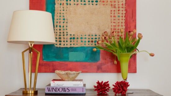 A mixed-media piece by Mary Reed fills a wall with vibrant color and texture.