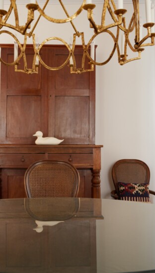  The floorplan is traditional with the dining room acting as a pass thru to the living spaces. A duck decoy, carved by David, sits on an heirloom sideboard.