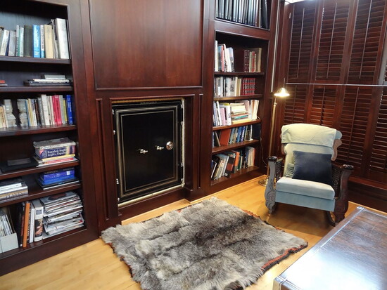 Private library with mahogany panneling featuring a built in 19th-Century safe from a saloon in Fulshear.