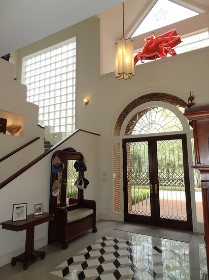 The main entry way featuring a 1920's Art Deco Pendant above a Venetian inspired marble & granite mosaic. 