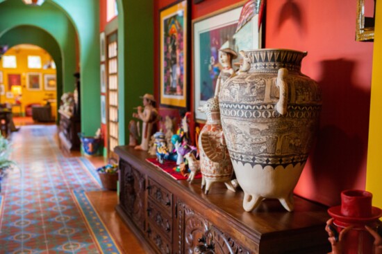 A collection of ceramic Catrinas from Michoacan are on display in the gallery/hallway.