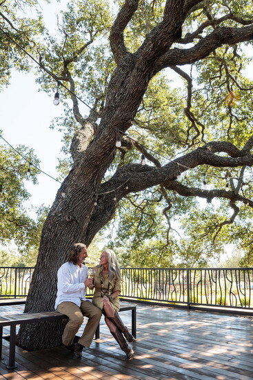 Outdoor seating areas at Seasons welcome guests to gather beneath the trees and take in the natural beauty of the Hill Country.