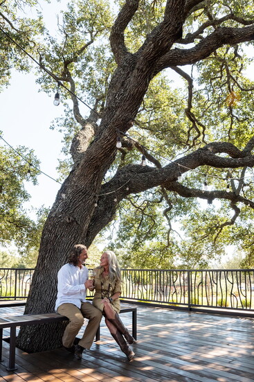 Outdoor seating areas at Seasons welcome guests to gather beneath the trees and take in the natural beauty of the Hill Country.