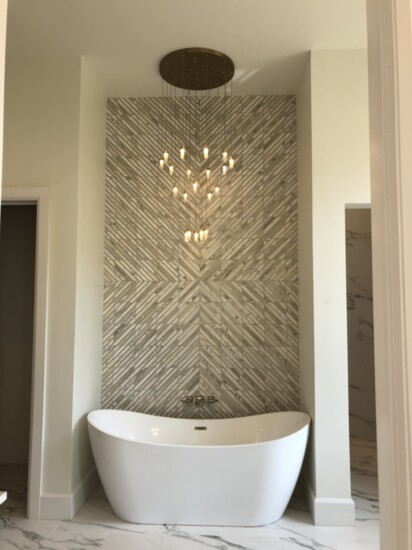 The brass and marble mosaic tile inlay is the focal point in this master bath.
