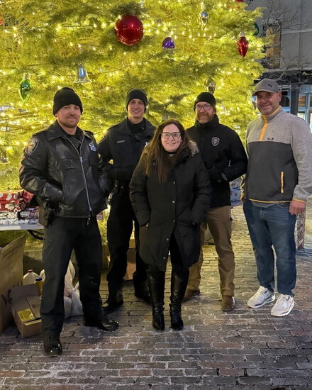 A group of Portsmouth Police Officers and volunteers hand out gifts in Market Square