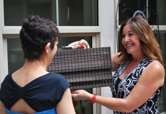 Marva Don demonstrates textiles to a client PC Lance Thompson