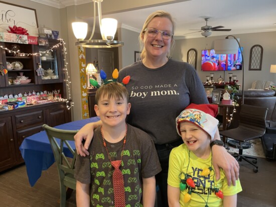 Rebekah Lloyd poses for a photo with her sons at a cookie decorating party. 