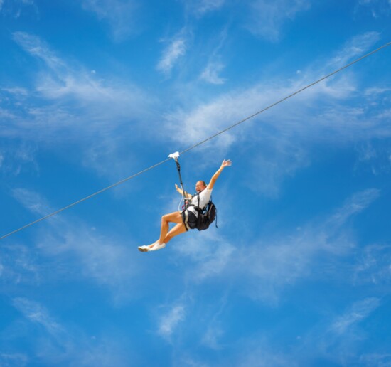 A young woman finds her thrills on one of Skytrail's zip lines.