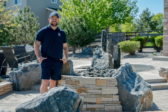 Owner Jon LeDuc, Duke's Landscape Company with a client's finished firepit and backyard sanctuary.