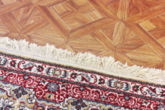 Attaching double-sided tape to rugs helps prevent tripping.