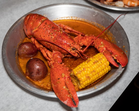 A scrumptious whole lobster boil is ready to be feasted upon.