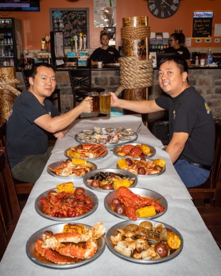 Co-owners Nan and Jay Weng toast at feast at the Storming Crab.