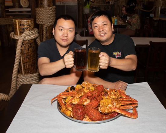 Co-owners Nan and Jay Weng toast over an expansive boiled combo platter.