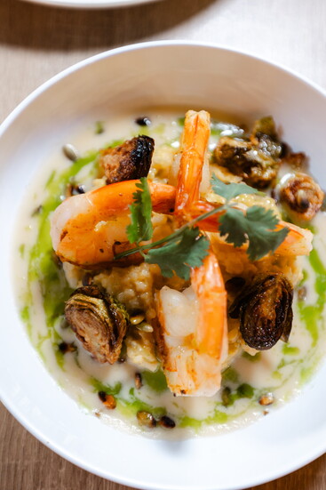 Grilled Jumbo Shrimp with Coconut Milk Risotto, Charred Brussel Sprouts, Lemongrass Butter Sauce, Roasted Pepitas and Lime