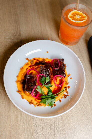 Neon Fig Pork Belly Smokey Romesco with Pickled Shallot and Chorizo Crumble