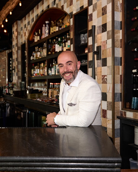 Adrian Costa, at the granite bar his company installed in Restaurant Bricco in West Hartford. Photo by John Helmke