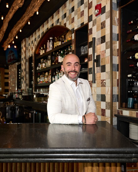 Adrian Costa, at the granite bar his company installed in Restaurant Bricco in West Hartford. Photo by John Helmke
