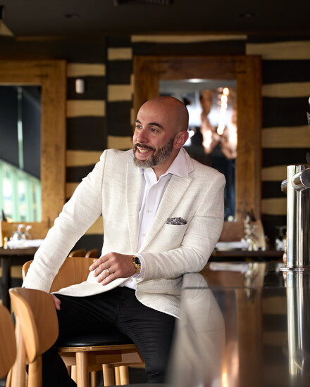 Adrian Costa, at the granite bar his company installed in Restaurant Bricco in West Hartford. Photo by John Helmke