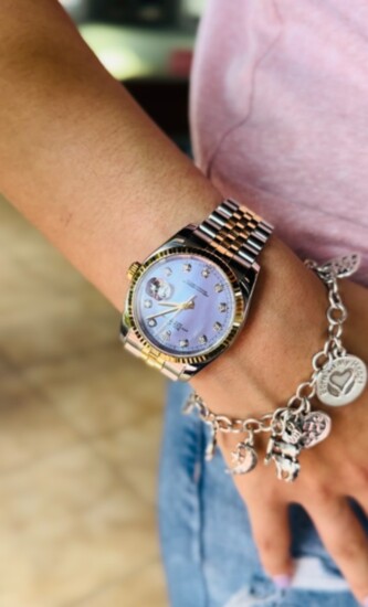 Feminize an oversized Rolex by layering