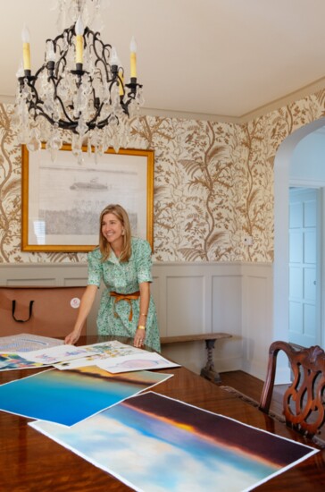 Amanda previews new works in her dining room, with Carroll Cloar study hanging behind her