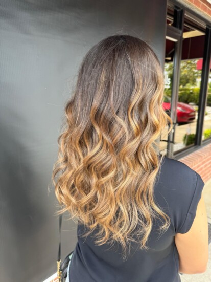 Amber shows off her talent with a client's balayage and style.