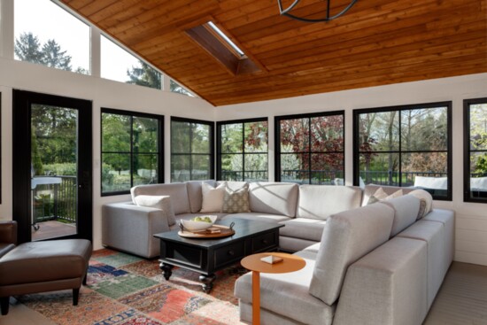 A stunning sun room complete with floor-to-ceiling windows