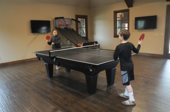 Cooper and Creed Kardokus spend hours in the new pool house playing ping pong, shooting hoops or watching sports.