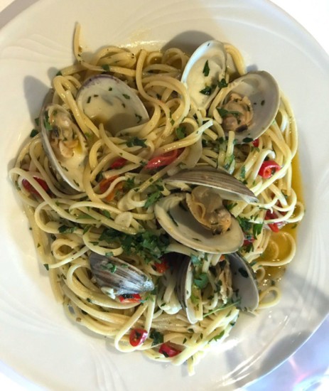 Linguini Pescatore, a spicy seafood dish with scallops, clams, mussels, tomatoes, garlic, basil, and fresh Calabrian chiles grown in the garden