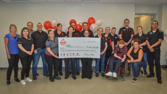 Jami Salyers, on the far left, joins her team with a significant donatiopn to United Cerebral Palsy of Southern Arizona