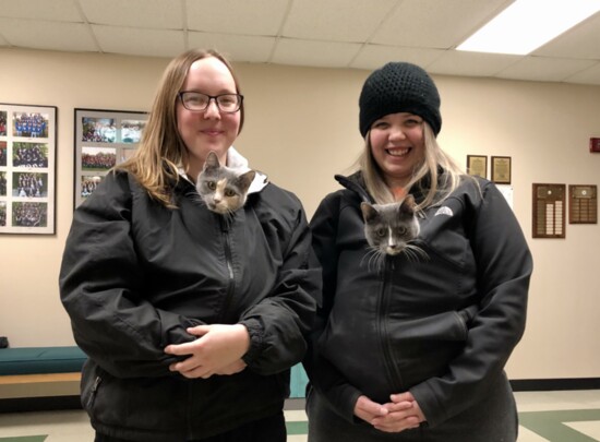 Carissa Sprout and Paige Stowell pose with kittens.