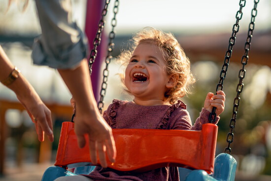 Swing with your littles at the playground