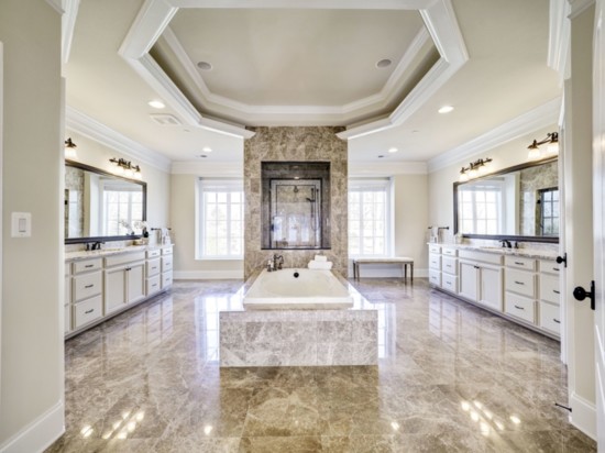 The Master Bathroom drips in luxury. Marble his/hers vanities and a separate oversized shower with glass overlooking the deep tub make this a room to relish