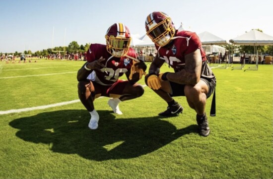 Marcus at the 2019 fall camp for the Redskins; he and a teammate getting ready for practice.