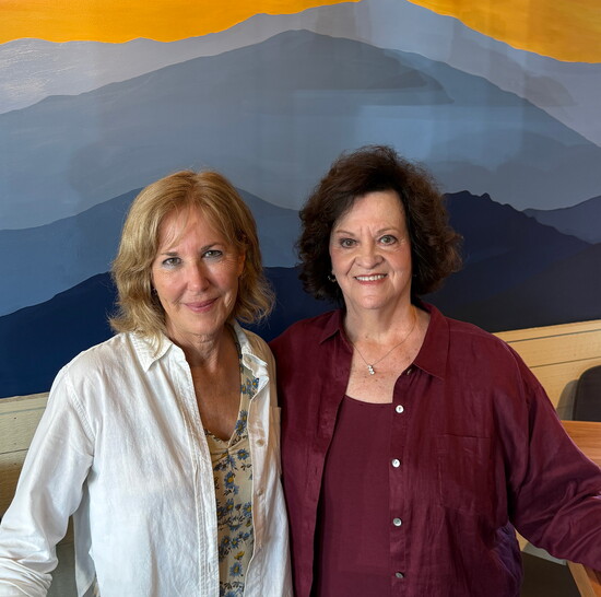 Sharon Oldham and Sharon Benton in front of a mural painted by Tanya Myers. Photo: Amy Campbell