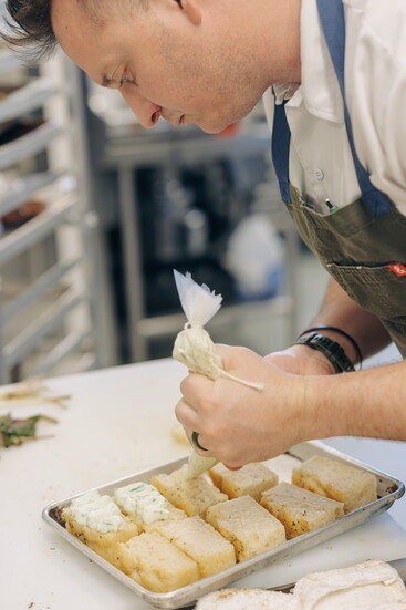 Chef Garret Kasper prepares fresh, farm-inspired dishes at Arbor Day Farm, showcasing seasonal ingredients and sustainable flavors.
