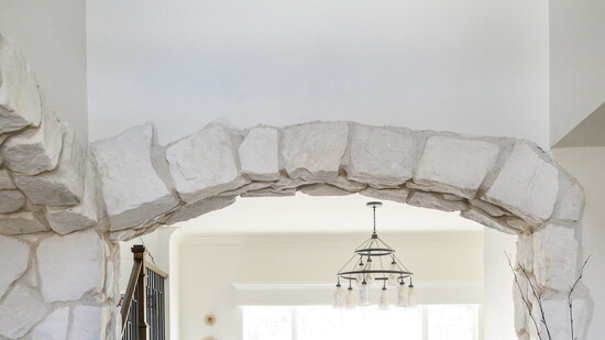 An arched stone entryway invites one to sit and stay