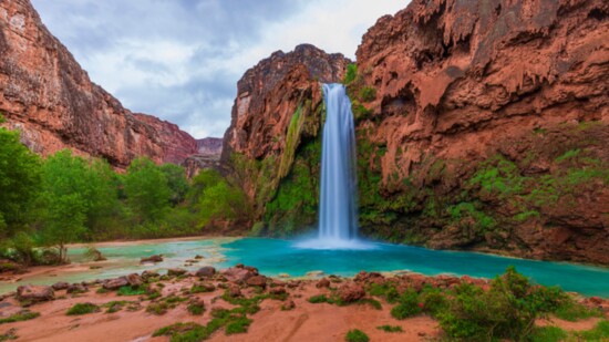 Havasu Falls is the most famous of the aqua-blue Havasupai Waterfalls that spill over deep-orange, travertine cliffs in a desert oasis of stunning beauty. The s