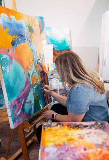 Jess Tinsley Painting in her studio. Photo by Erica Haskett