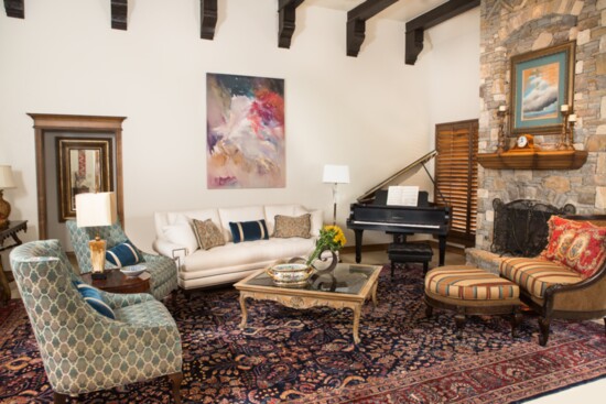 The painting over a fireplace, acquired by the client’s husband, serves as the centerpiece for a redesign in the living room of an Edmond home. (Carli Wentworth