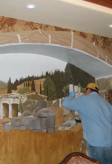 Aaron painting this Greek library ruin in a large inset in a dining room to bring in some outdoor elements to a formal room. 