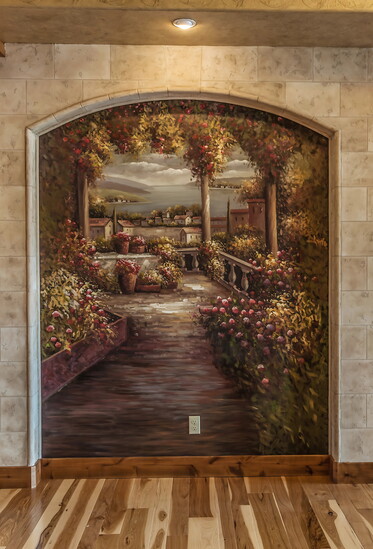 This trompe l’oeil mural of an Italian seaside garden, framed by faux stone trim, creates the illusion of a walk-in escape.