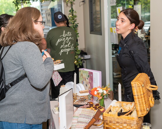 A Nossi student discusses her project with a guest during the senior exhibition day.