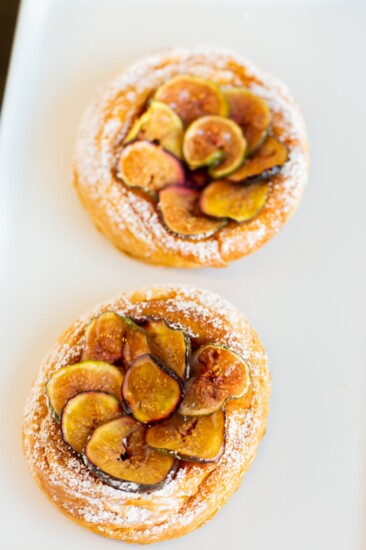 Fig tart, a croissant base filled with thin layer of almond cream with raspberry jam, and figs on top.  