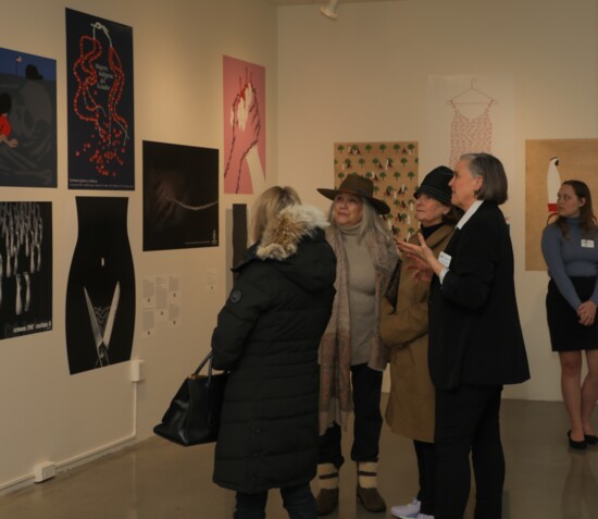 Carey Mack Weber discusses images at the "Women's Rights are Human Rights" exhibition last spring.