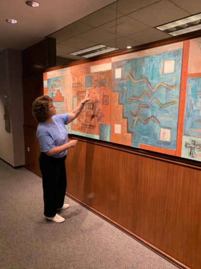 SRP's Ileen Snoddy explains a painting. Photo provided