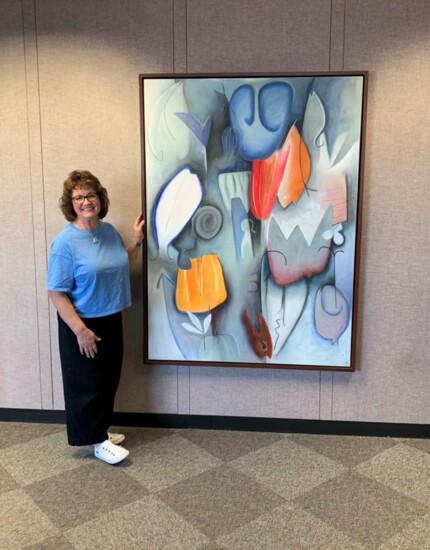 SRP's Ileen Snoddy stands next to "The Corridor" by Emmi Whitehorse. Photo provided