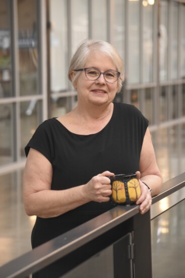 Ceramics artist Karen Eberhardt with one of her nature-inspired mugs.